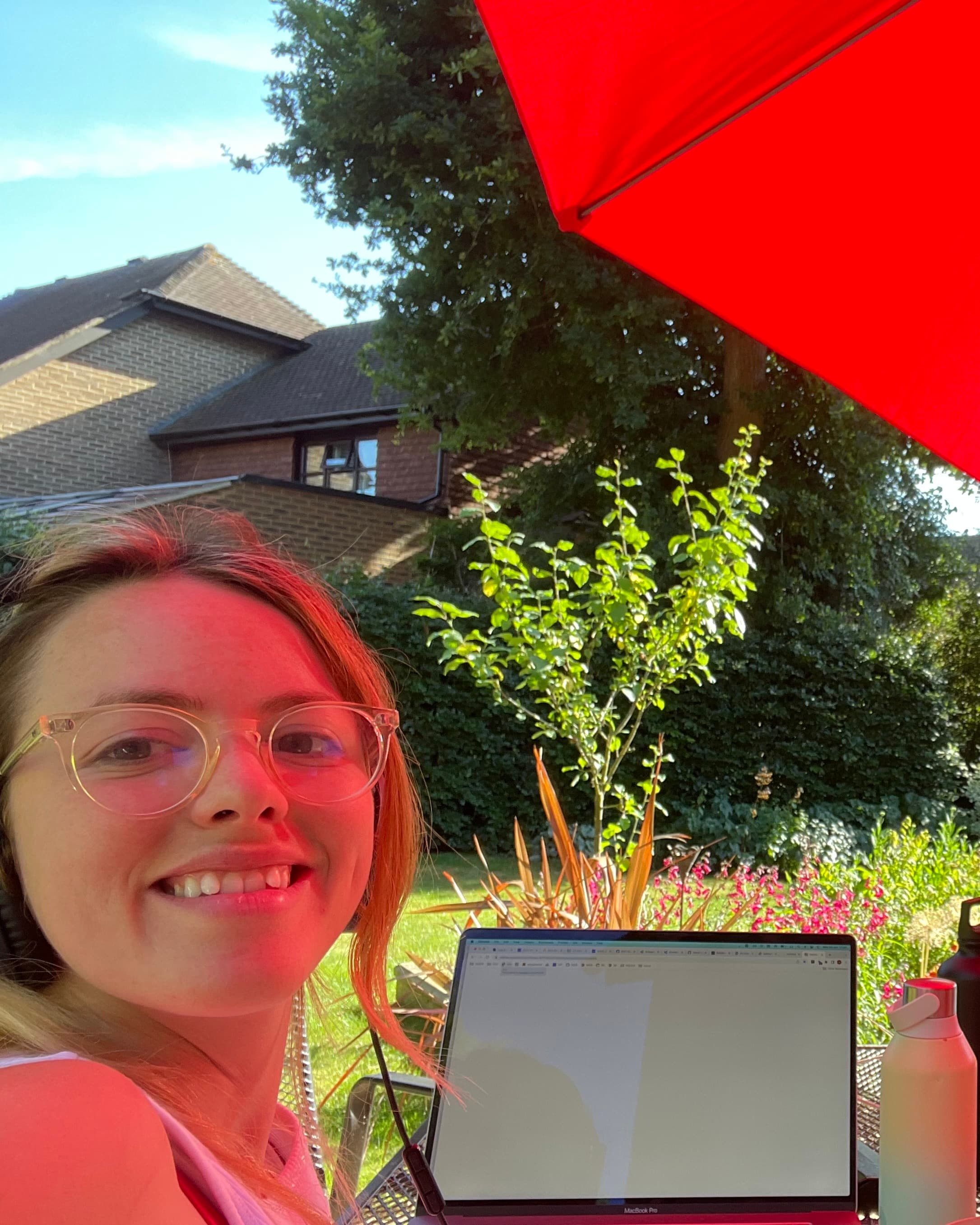hen coding outside in a garden under a parasol